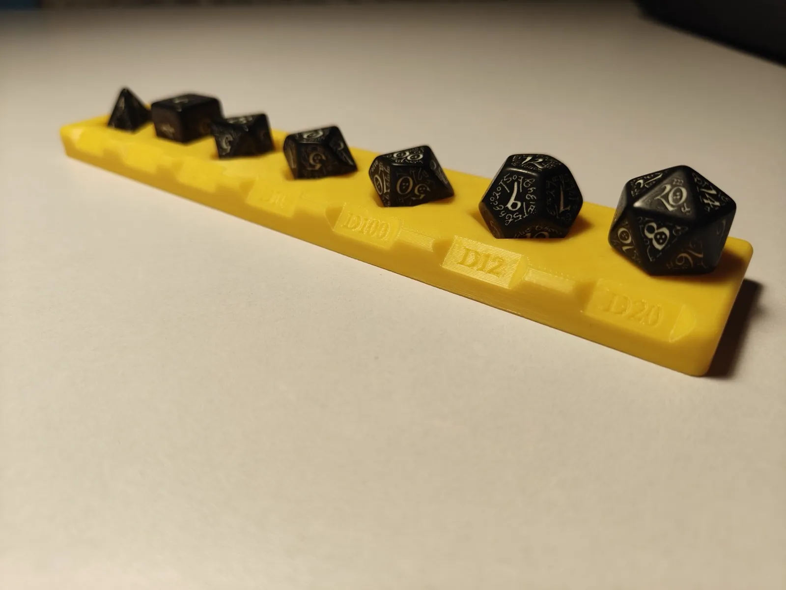 Set of black dice with gold symbols