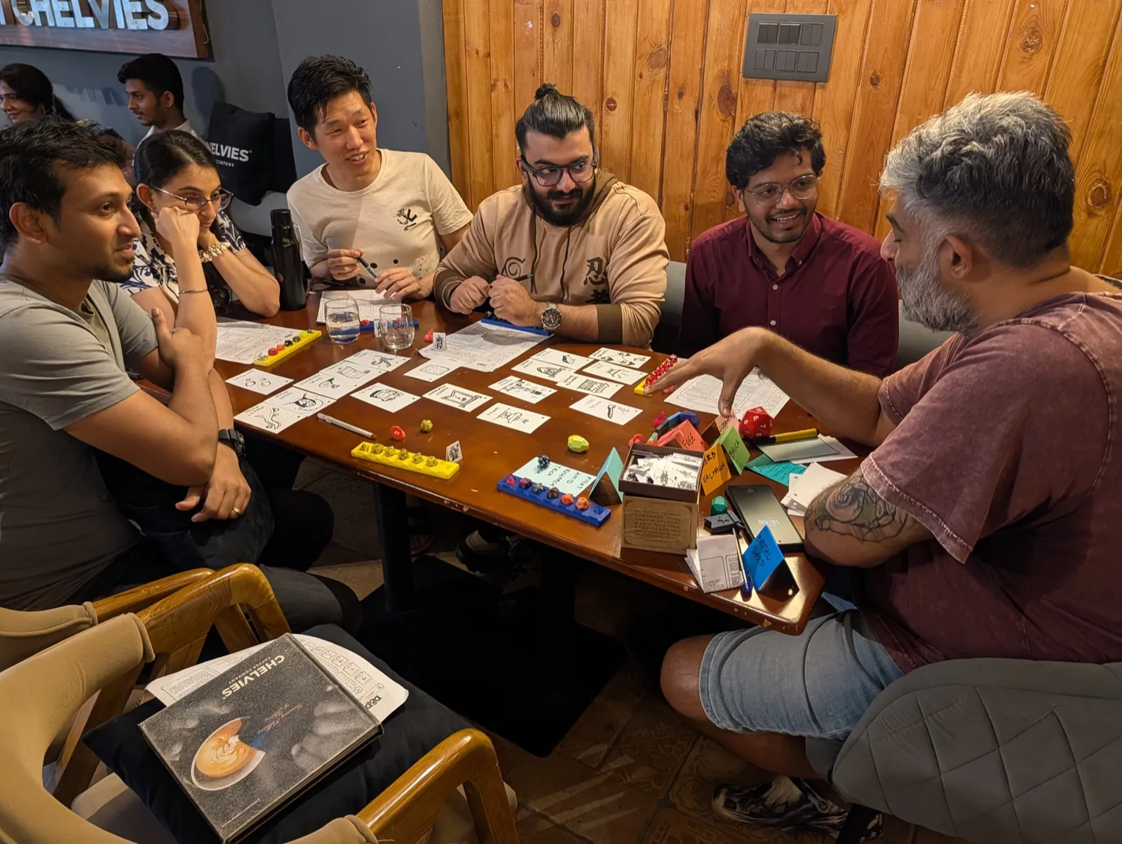 Facilitator standing and explaining the rules of a board game to players