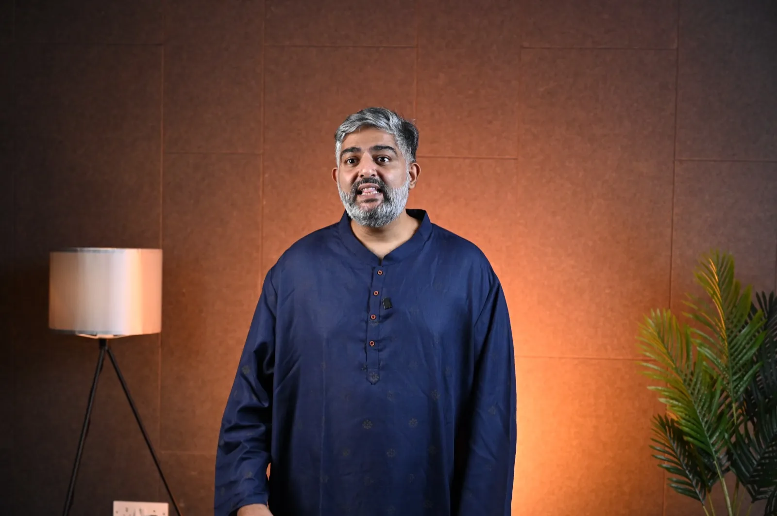Facilitator standing and presenting to camera