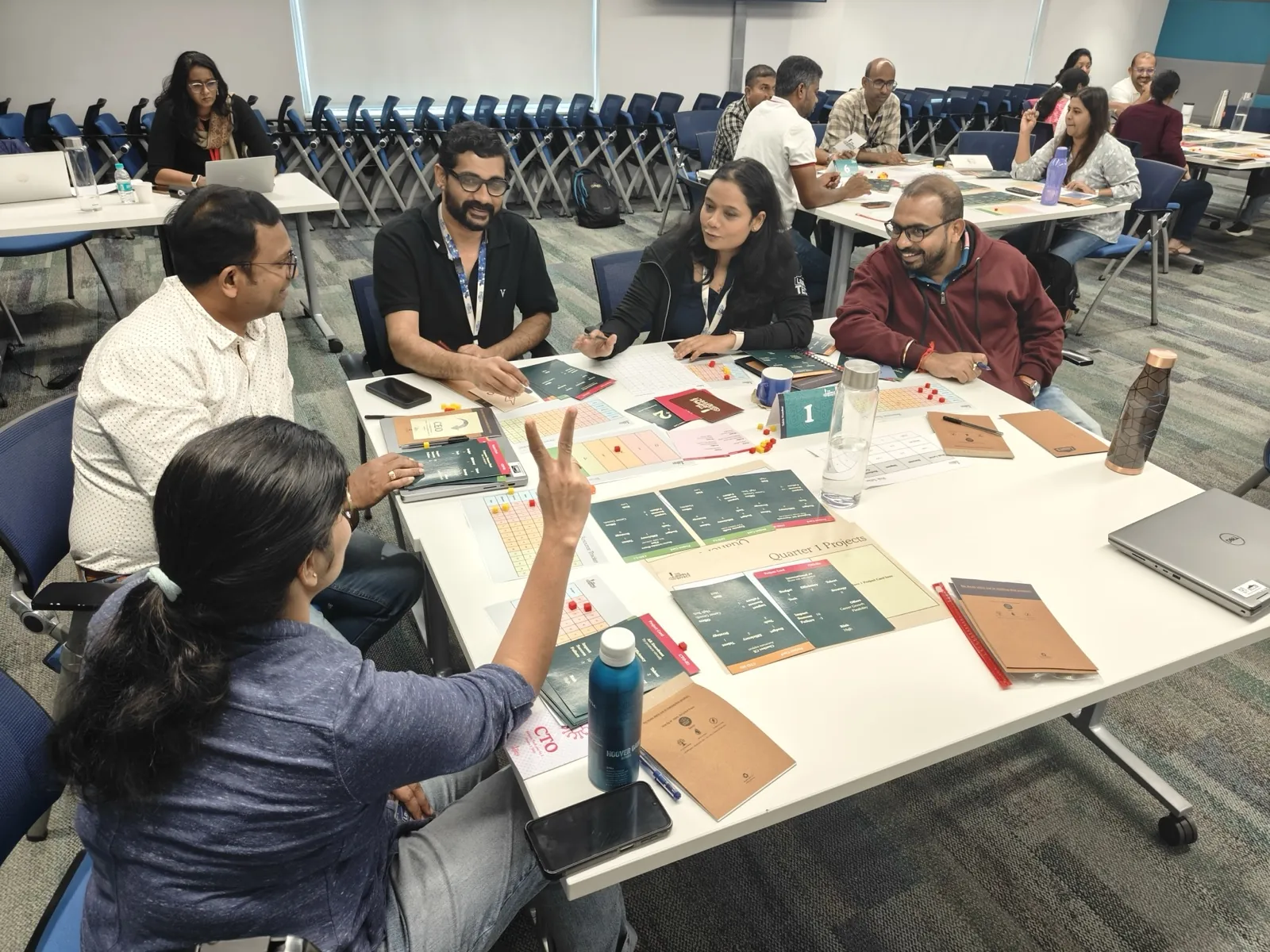 Group of colleagues playing a board game together during a team workshop