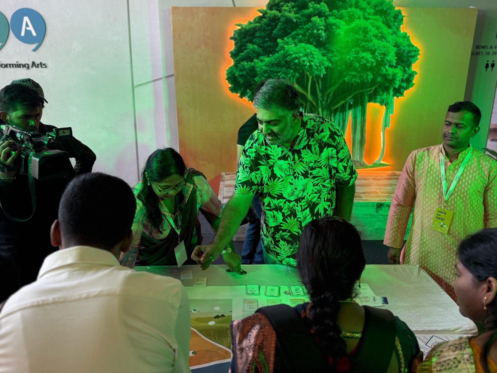 Employees around a table playing a facilitated serious game at a corporate team-building session
