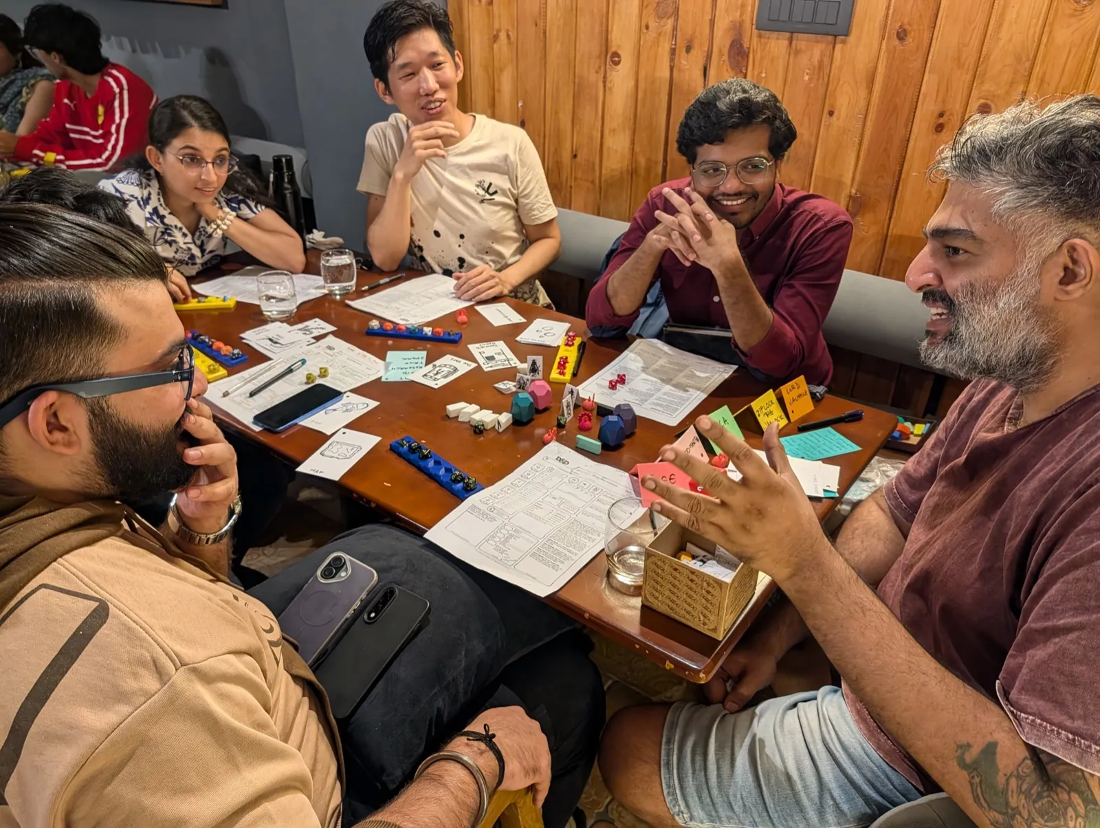 Team engaged in a tabletop strategy game at a leadership workshop